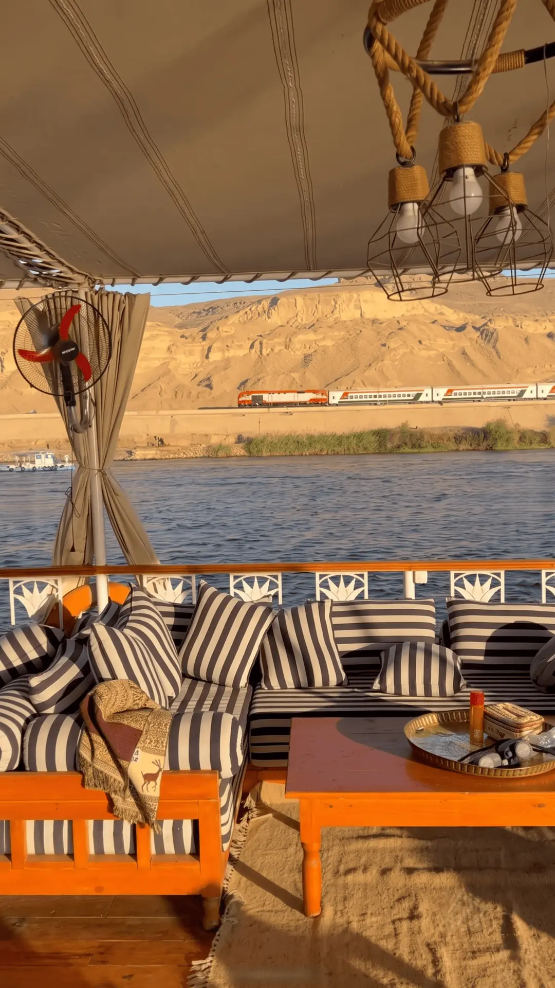 Interesting view of a passing train seen from the deck of a dahabiya on the Nile River