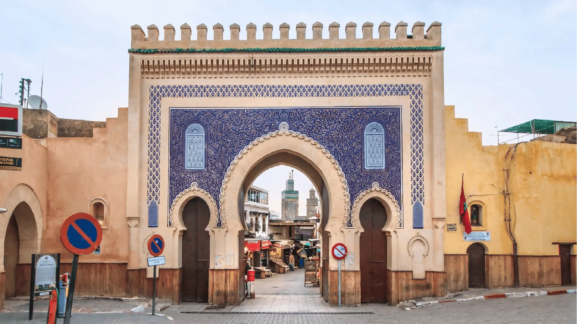 Historic Bab Bou Jeloud gate with blue zellige tiles and arches at the entrance of Fez Medina Morocco