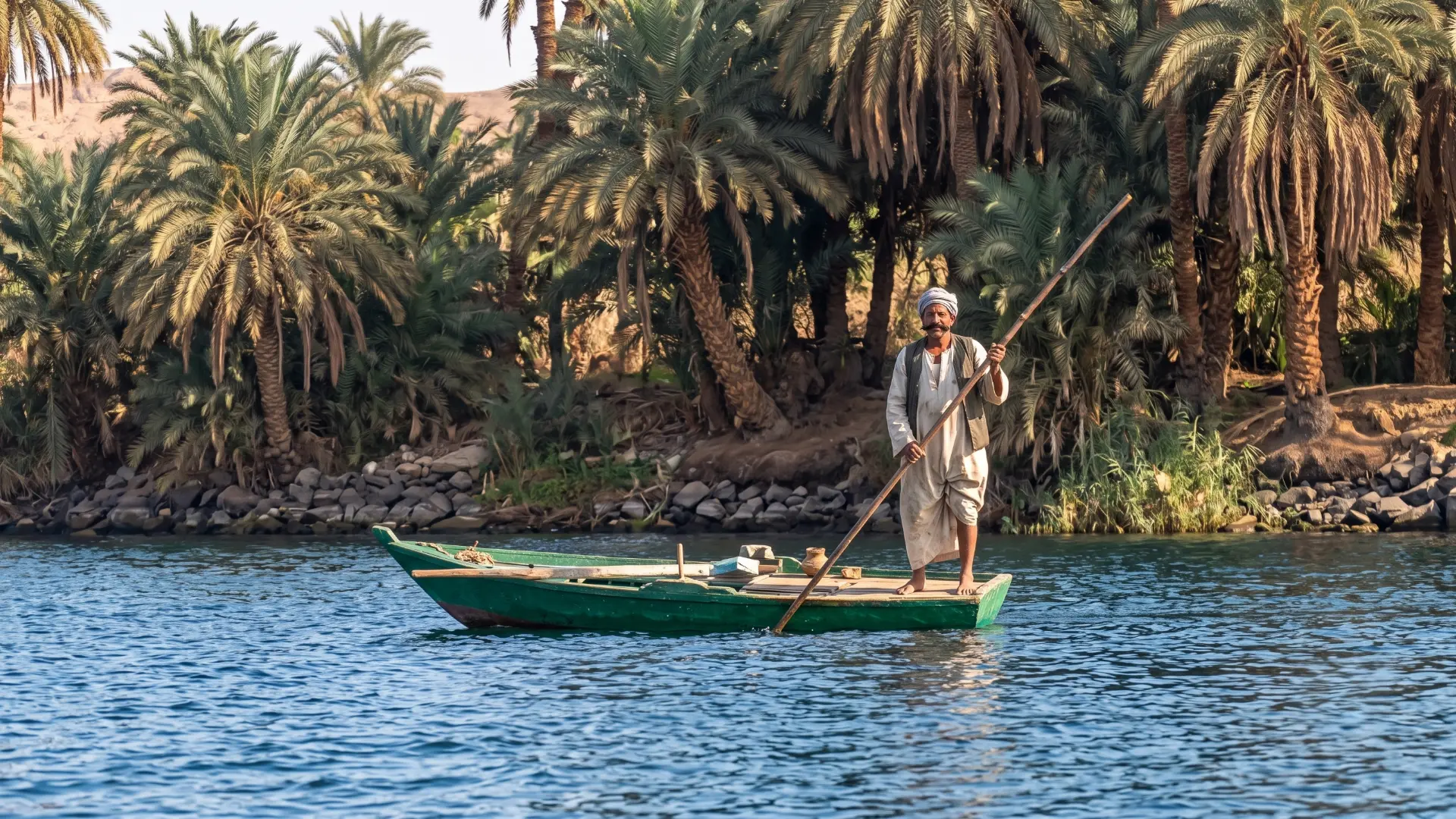 Traditional fisherman working on the Nile River in Egypt with a dahabiya cruise boat in the background