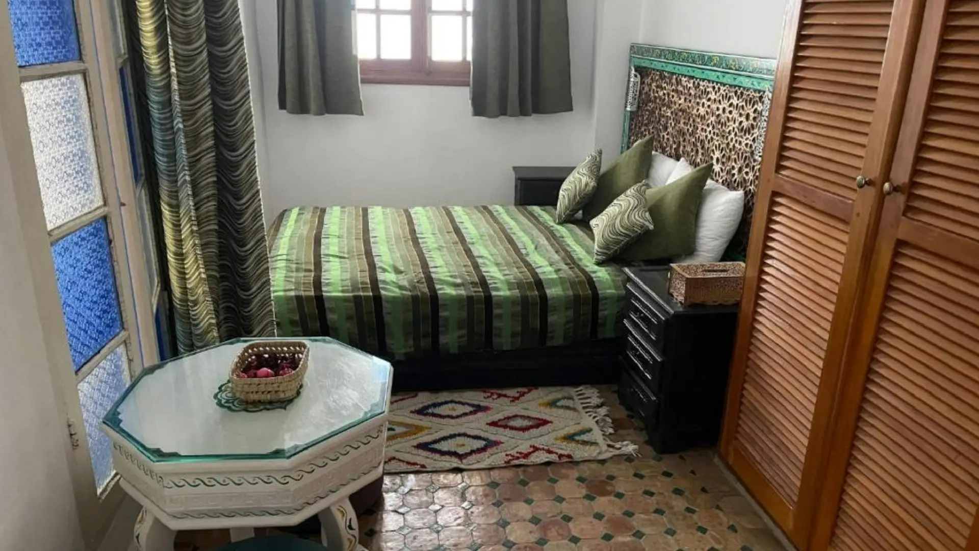 Cozy and stylish guest room at Riad Aicha in Asilah, Morocco