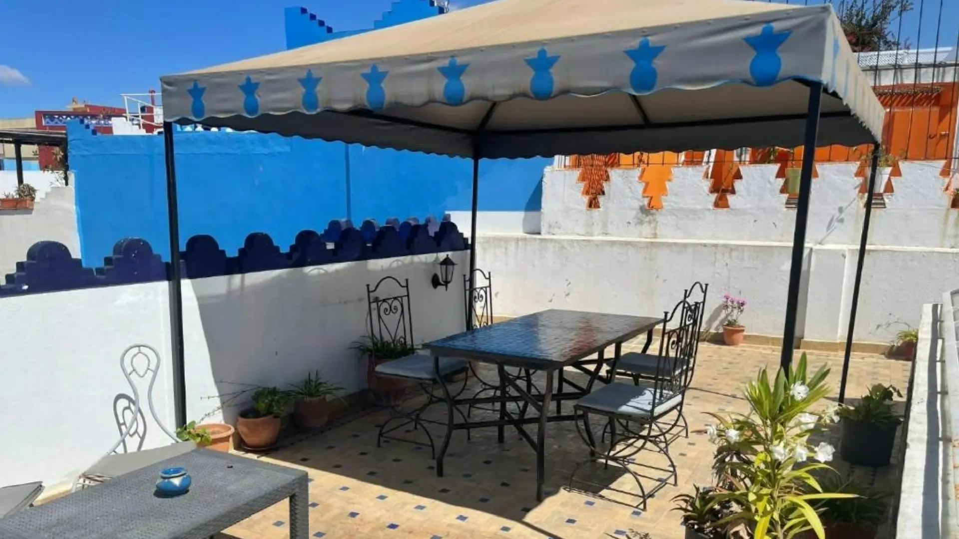 Sunny rooftop terrace at Riad Aicha with sea views in Asilah